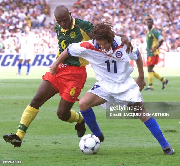 Chilean forward Marcelo Salas and Cameroonian defender Pierre Njanka tackle for the ball 23 June during the1998 Soccer World Cup group B match...