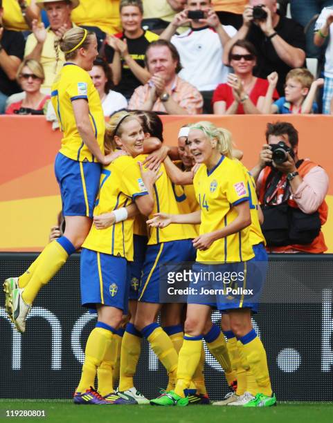 Lotta Schelin of Sweden celebrates with her team mates after scoring her team's first goal during the FIFA Women's 3rd Place Playoff match between...