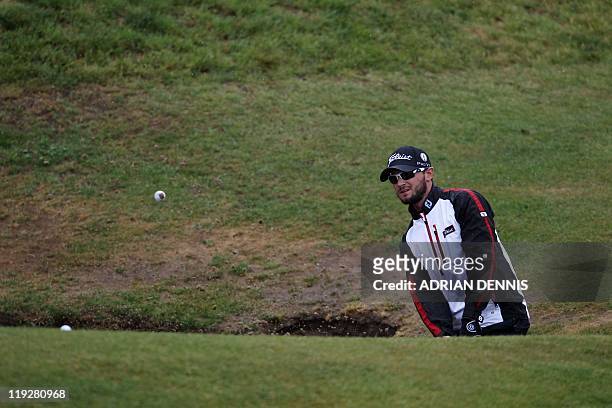 Golfer Kyle Stanley plays out of a bunker on the 6th hole, on the third day of the 140th British Open Golf championship at Royal St George's in...
