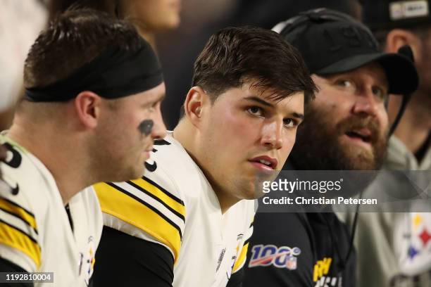 Quarterback Mason Rudolph of the Pittsburgh Steelers sits alongside Devlin Hodges and Ben Roethlisberger during the second half of the NFL game...