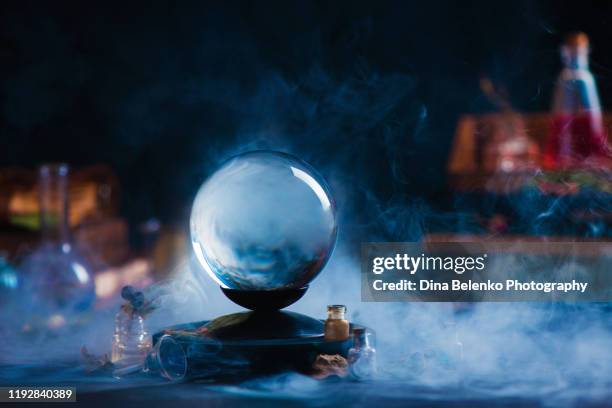 crystal ball with occult equipment and mysterious smoke. magical header with copy space - halloween ball stockfoto's en -beelden