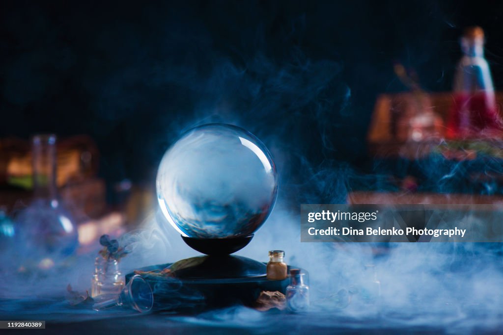 Crystal ball with occult equipment and mysterious smoke. Magical header with copy space