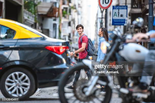 glimlachend jonge toeristen die het drukke centrum van buenos aires verkennen - cars on motor way stockfoto's en -beelden