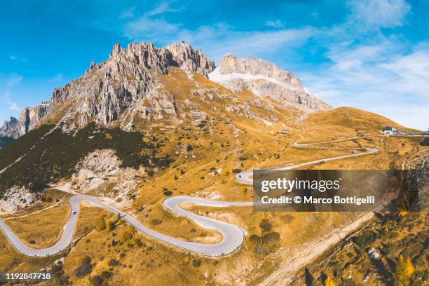 aerial view of mountain road at sass pordoi, dolomites, italy - sass pordoi foto e immagini stock
