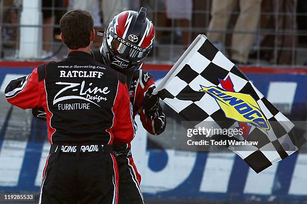 Crew chief Jason Ratcliff celebrates with Kyle Busch, driver of the Z-Line Designs Toyota, after Busch won the NASCAR Nationwide Series New England...