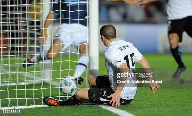 July 06: Diego Perez of Uruguay kicks the ball to score against Argentina during 2011 Copa America soccer match as part of quaters final at Brigadier...