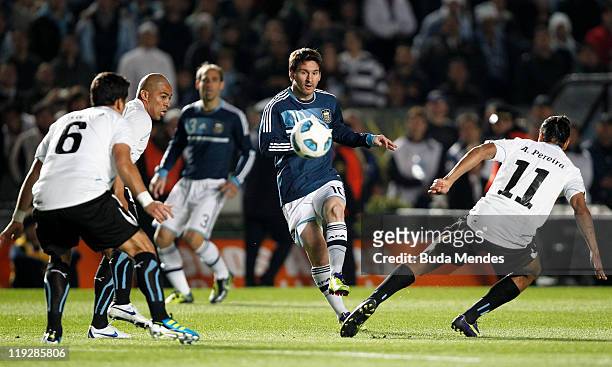 Lionel Messi of Argentina struggles for the ball with Mauricio Victorino and Alvaro Pereira of Uruguay during a match as part of Copa America 2011...