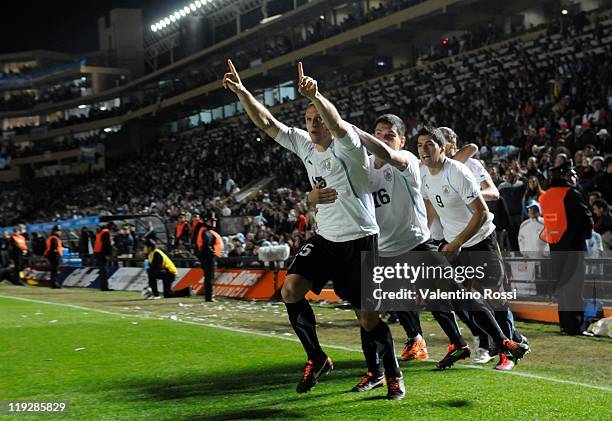 July 16: Uruguay's Diego Perez celebrate a score goal against Argentina during a match between Argentina and Uruguay as part of quarters final at...