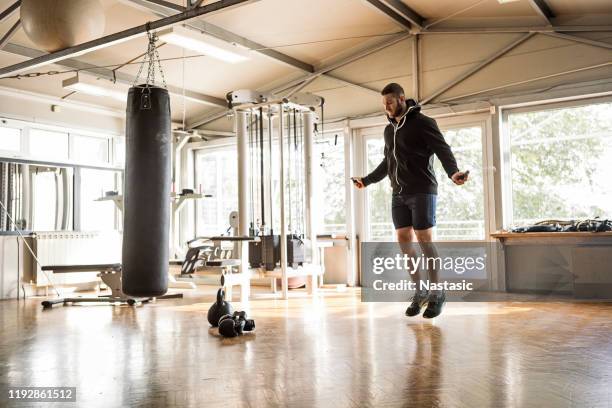 boxer jumping rope in gym worming up - boxing gym stock pictures, royalty-free photos & images