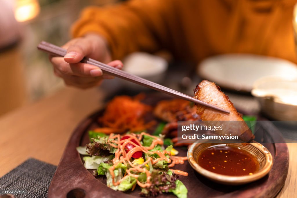 Asian woman tasting Thai food in the restaurant