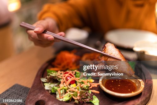 Asian woman tasting Thai food in the restaurant Asian woman tasting Thai food in the restaurant