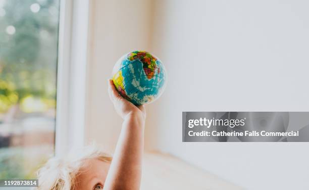 child holding globe ball - world war 1 aircraft stock-fotos und bilder