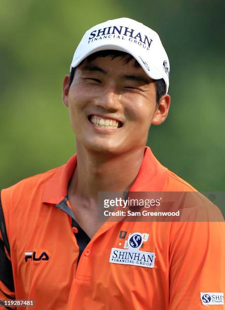 Sunghoon Kang of Korea smiles after a birdie on the 16th hole during the third round of the Viking Classic at Annandale Golf Club on July 16, 2011 in...