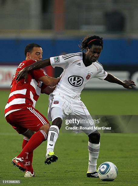 Joseph Ngwenya of the D.C. United dribbles the ball past Daniel Hernandez of the FC Dallas at Pizza Hut Park on July 16, 2011 in Frisco, Texas.