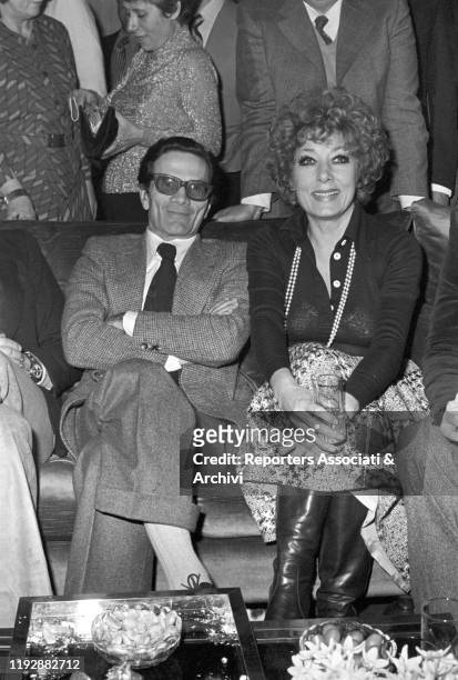 Italian director Pier Paolo Pasolini attending to a party with Italian actress Lauretta Masiero. Rome, 1975