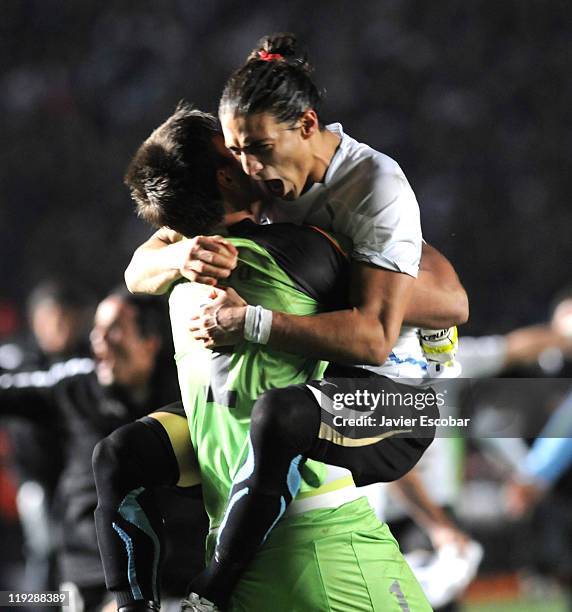 Fernando Muslera and Martín Cáceres of Uruguay celebrate after the game between Argentina and Uruguay as part of quarter final of the 2011 Copa...