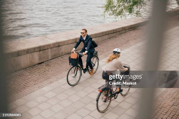 high angle view of people riding bicycles on footpath in city - commuter cycling stock pictures, royalty-free photos & images