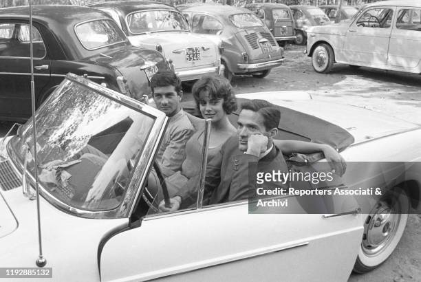 Italian writer and director Pier Paolo Pasolini sitting in the car with Italian acress Anna Maria Ferrero and French actor Jean-Claude Brialy on the...