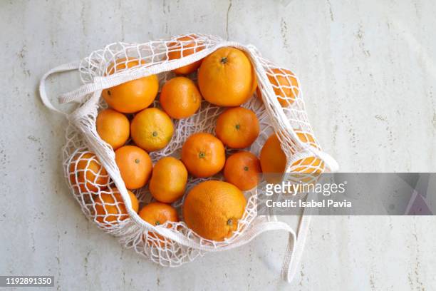 oranges and tangerines in reusable  shopping bag - tangerine stock pictures, royalty-free photos & images