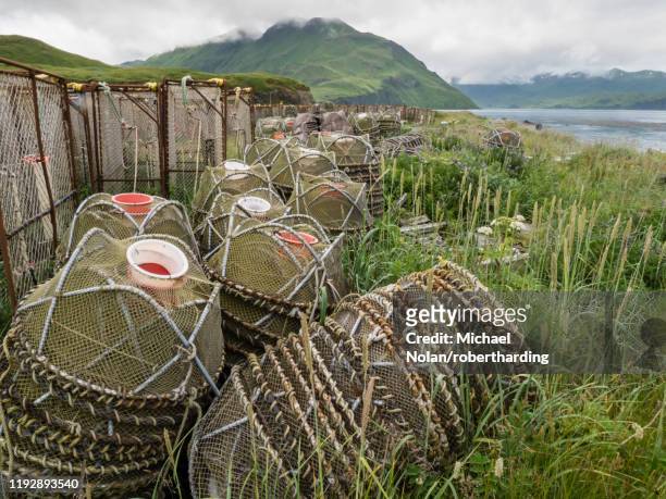 crab fishing pots being stored at the dock in dutch harbor in the community of unalaska, alaska, united states of america, north america - dutch harbor stock pictures, royalty-free photos & images