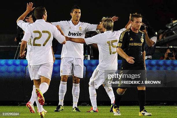 Real Madrid's Cristiano Ronaldo celebrates with teammates Nacho and Fabio Coentrao after scoring against the LA Galaxy at the Los Angeles Coliseum on...