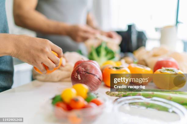 närbild foto av kvinnans hand samtidigt förbereda vegansk mat hemma - asian man cooking bildbanksfoton och bilder