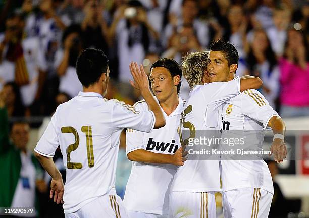 Cristiano Ronaldo of Real Madrid is congratulated by his teammates Fabio Coentrao, Mesut Ozil and Jose Callejon after scoring a goal against Los...