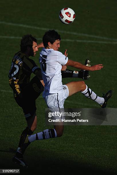 Andrew Durante of the Phoenix competes with Sean Lovmore of the Junior All Whites during the pre-season friendly match between the Wellington Phoenix...