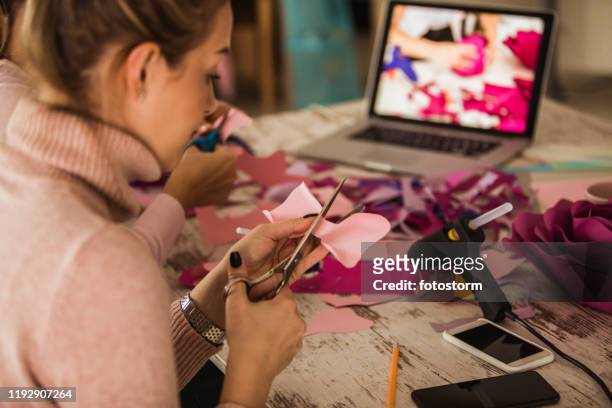 cutting out flower petals while crafting decorative paper flowers - craft stock pictures, royalty-free photos & images
