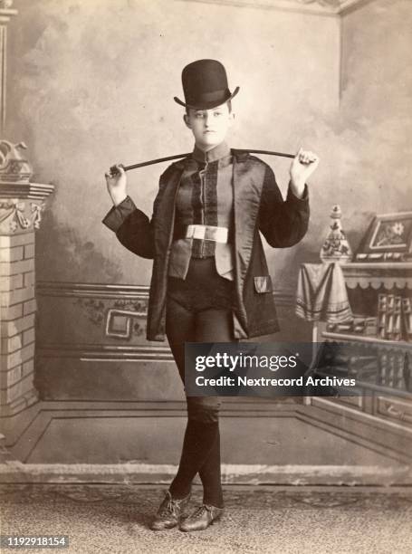 Cabinet Card portrait made in circa 1880 by Loupret Photo Studio in Lowell, Massachusetts. The woman portrayed wears the costume of a male horse...