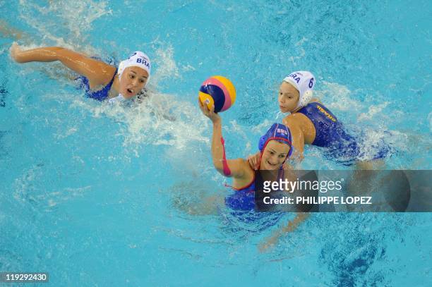 Russia's Natalia Ryshova-Alenicheva , Brazil's Cecilia Canetti and Brazil's Gabriela Leme Gozani compete in their group C women's water polo...