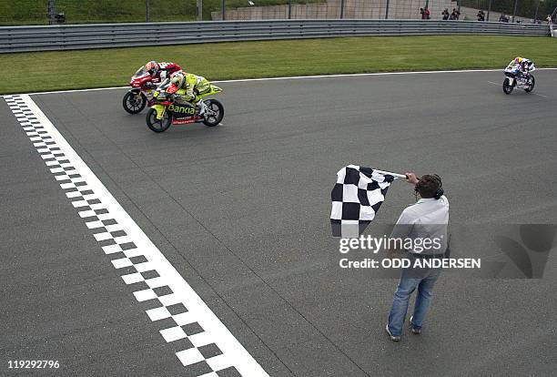 Winner Hector Faubel of Spain, second-placed French rider Johann Zarco and thrid-placed Maverick Vinales of Spain cross the finish line on July 17,...