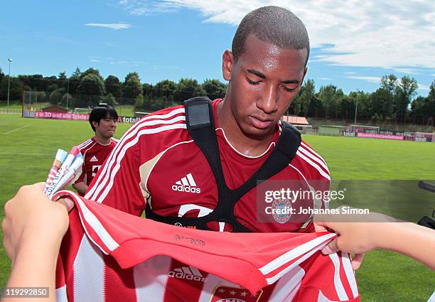New recruit Jerome Boateng signs autographs after the first FC Bayern training session at Saebener Strasse training ground on July 17, 2011 in...