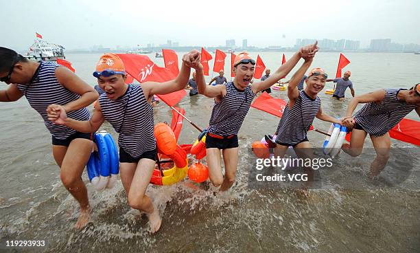 Swimmers celebrate after crossing the Yangtze River during the 38th International Yangtze River Crossing Festival on July 16, 2011 in Wuhan, Hubei...