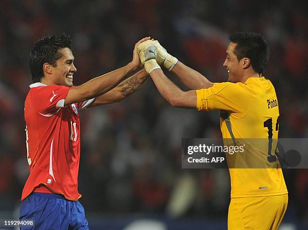 Chilean midfielder Luis Jimenez celebrates with his teammate Miguel Pinto after defeating Peru during a 2011 Copa America Group C first round...