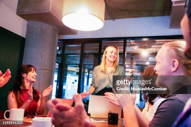 millennial female executive being applauded after a speech during a business meeting - encouragement stock pictures, royalty-free photos & images