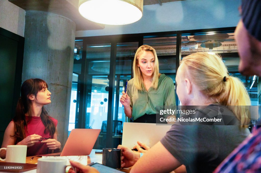 Young female manager has a serious talk with employee during a meeting
