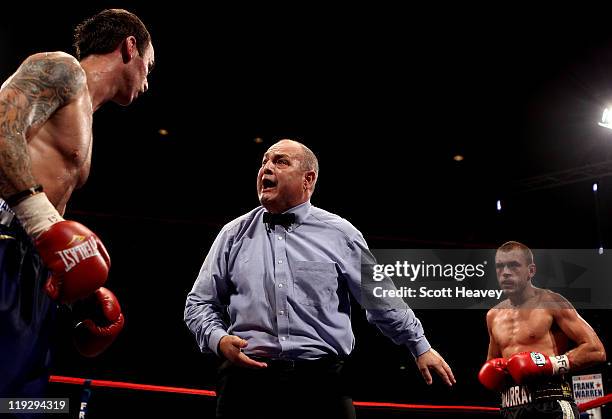 Referee Richie Davies has words with with Kevin Mitchell during the vacant WBO Inter-Continental Lightweight Championship bout against John Murray at...