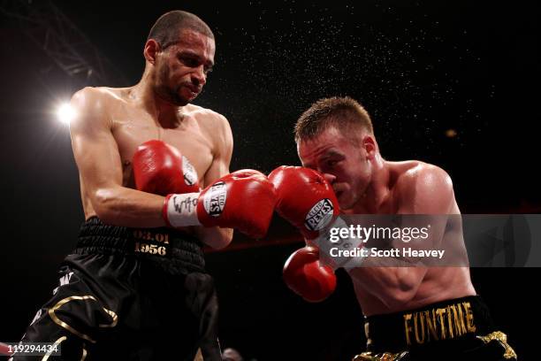 Frankie Gavin connects with Curtis Woodhouse during the WBO Intercontinental Welterweight Championship bout bout at Echo Arena on July 16, 2011 in...