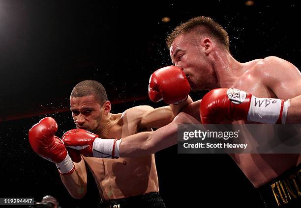 Frankie Gavin connects with Curtis Woodhouse during the WBO Intercontinental Welterweight Championship bout bout at Echo Arena on July 16, 2011 in...