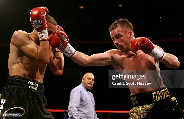 Frankie Gavin connects with Curtis Woodhouse during the WBO Intercontinental Welterweight Championship bout bout at Echo Arena on July 16, 2011 in...