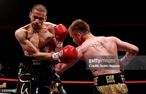 Frankie Gavin connects with Curtis Woodhouse during the WBO Intercontinental Welterweight Championship bout bout at Echo Arena on July 16, 2011 in...