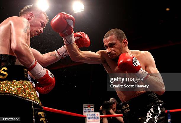 Frankie Gavin is caught by Curtis Woodhouse during the WBO Intercontinental Welterweight Championship bout bout at Echo Arena on July 16, 2011 in...