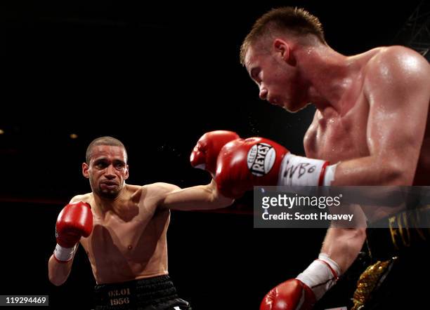 Frankie Gavin is caught by Curtis Woodhouse during the WBO Intercontinental Welterweight Championship bout bout at Echo Arena on July 16, 2011 in...
