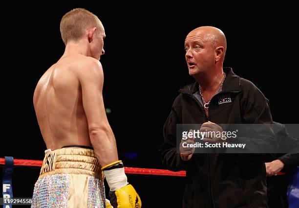 Paul Butlertalks to Dean Powell after his Super-Flyweight bout against Anwar Alfali at the Echo Arena on July 16, 2011 in Liverpool, England.