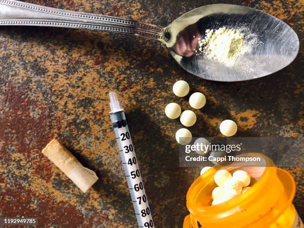 narcotic drugs with syringe and spoon - opioids stock-fotos und bilder