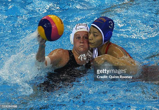 Megan Schooling of South Africa competes with Ping Liu of China in the Women's Water Polo first preliminary round match between South Africa and...