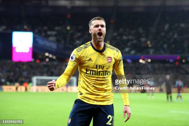 Callum Chambers of Arsenal celebrates their second goal scored by Pierre-Emerick Aubameyang during the Premier League match between West Ham United...