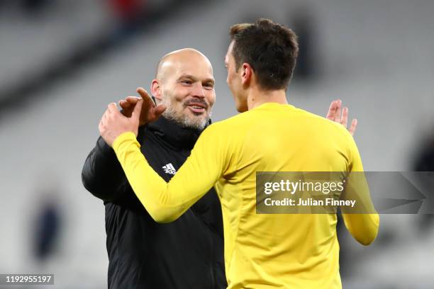 Freddie Ljungberg, Interim Manager of Arsenal and Mesut Ozil of Arsenal celebrate victory during the Premier League match between West Ham United and...