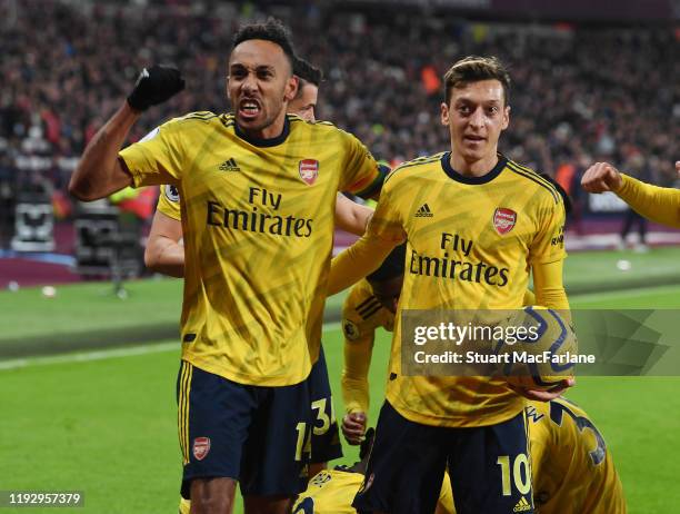 Pierre-Emerick Aubameyang celebrates the 2nd Arsenal goal with Mesut Ozil during the Premier League match between West Ham United and Arsenal FC at...